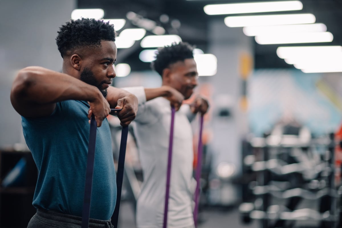 Two men working side by side, supported and in step — growing together